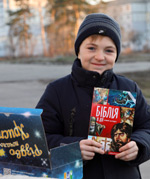 Boy holding a children's Bible