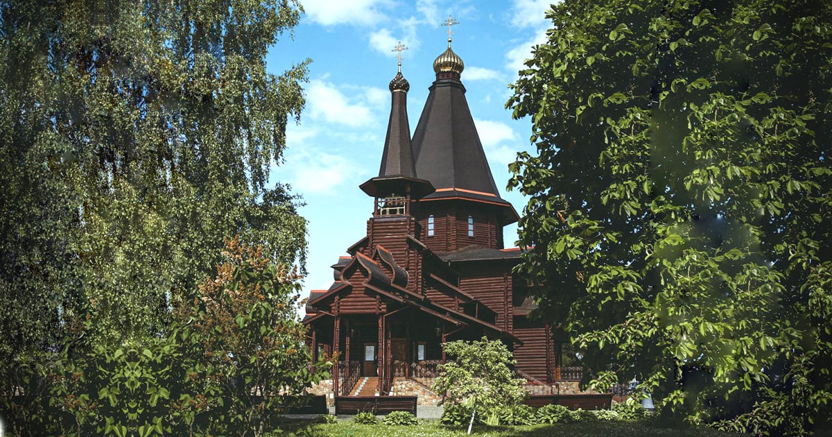 A church is seen between two trees.