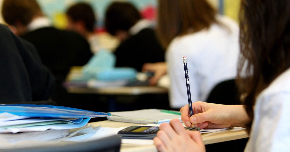 Students sitting in a classroom. Students sitting in a classroom.