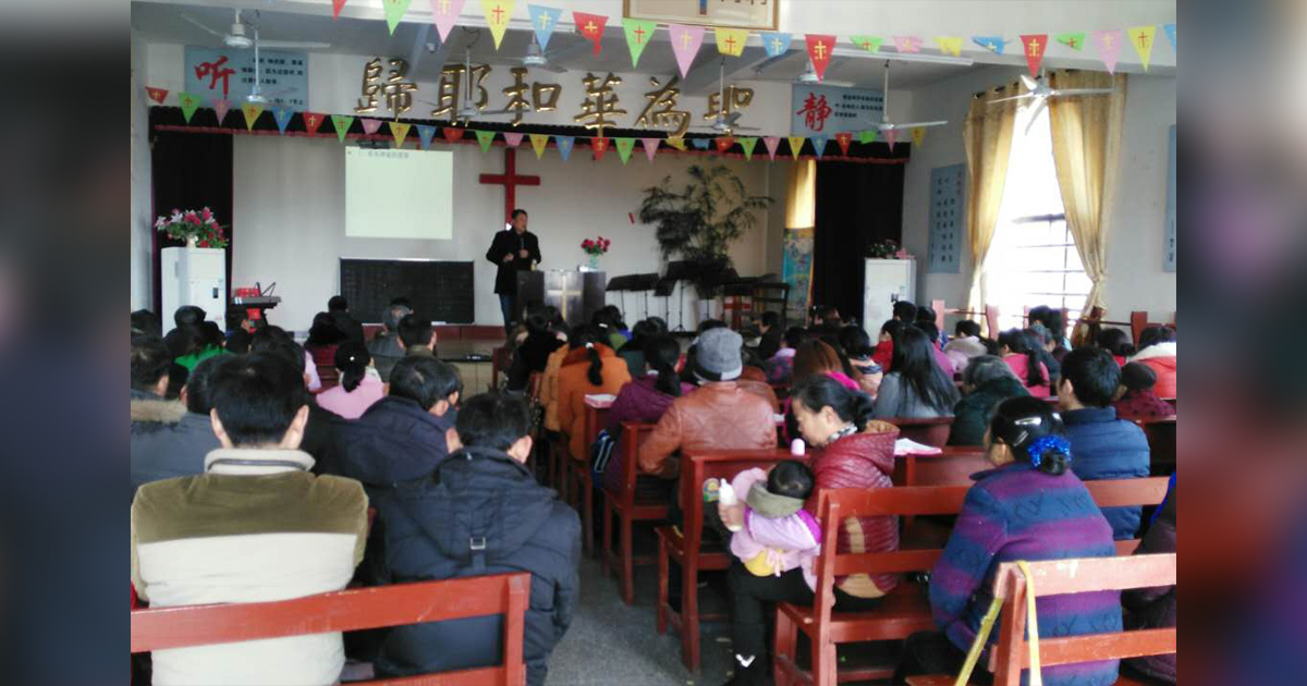 Believers are sitting on benches as they listen to God's Word. Believers are sitting on benches as they listen to God's Word.