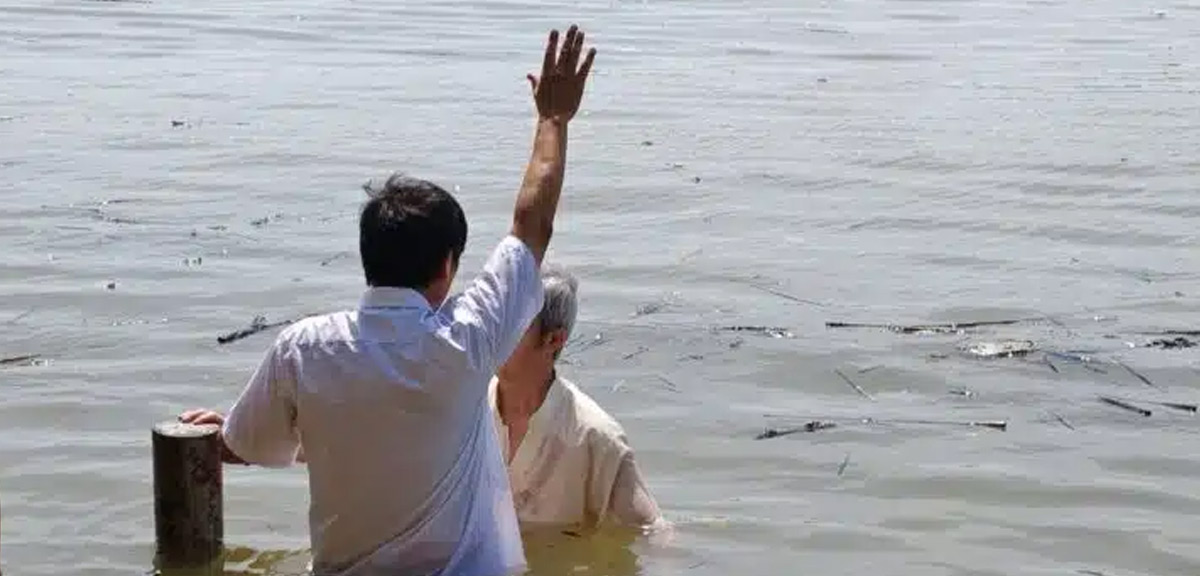 John Cao is baptizing a believer. John Cao is baptizing a believer.