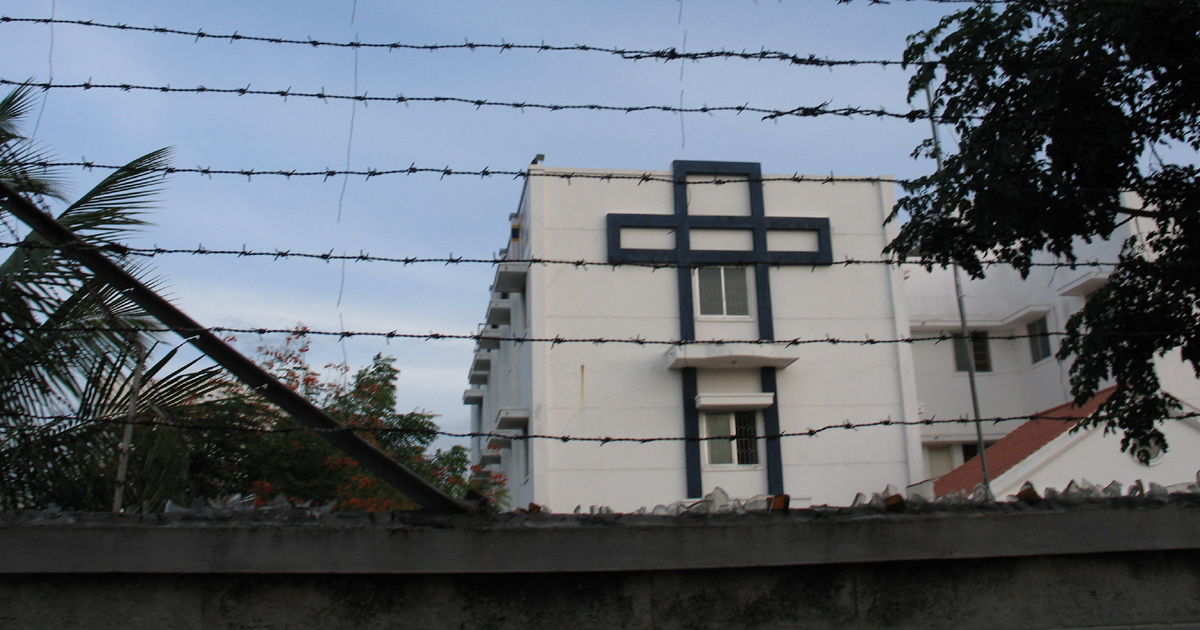 A church in India behind a protective fence with barbed wire. A church in India behind a protective fence with barbed wire.