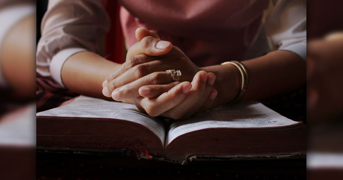 Woman's hands folded in prayer Woman's hands folded in prayer