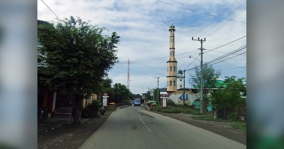 A street is lined with buildings and trees.