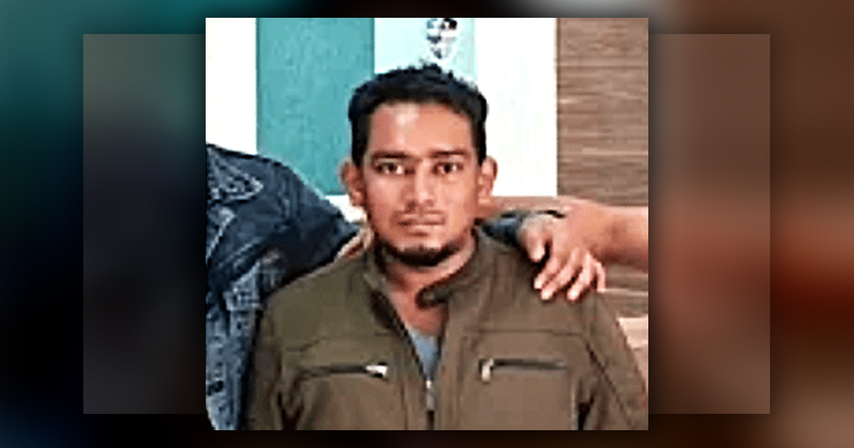 Dedi Saputra has two people's arms around his shoulders. Dedi Saputra has two people's arms around his shoulders.