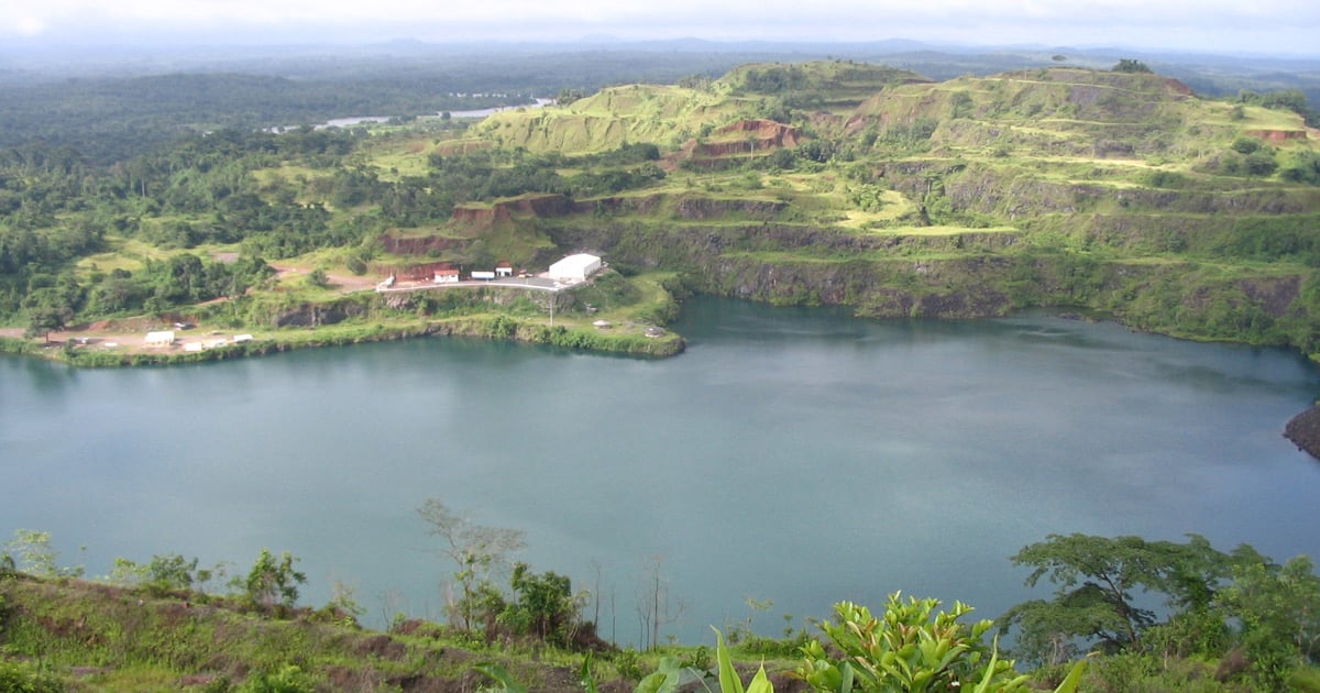A lake is surrounded by tree covered hills.