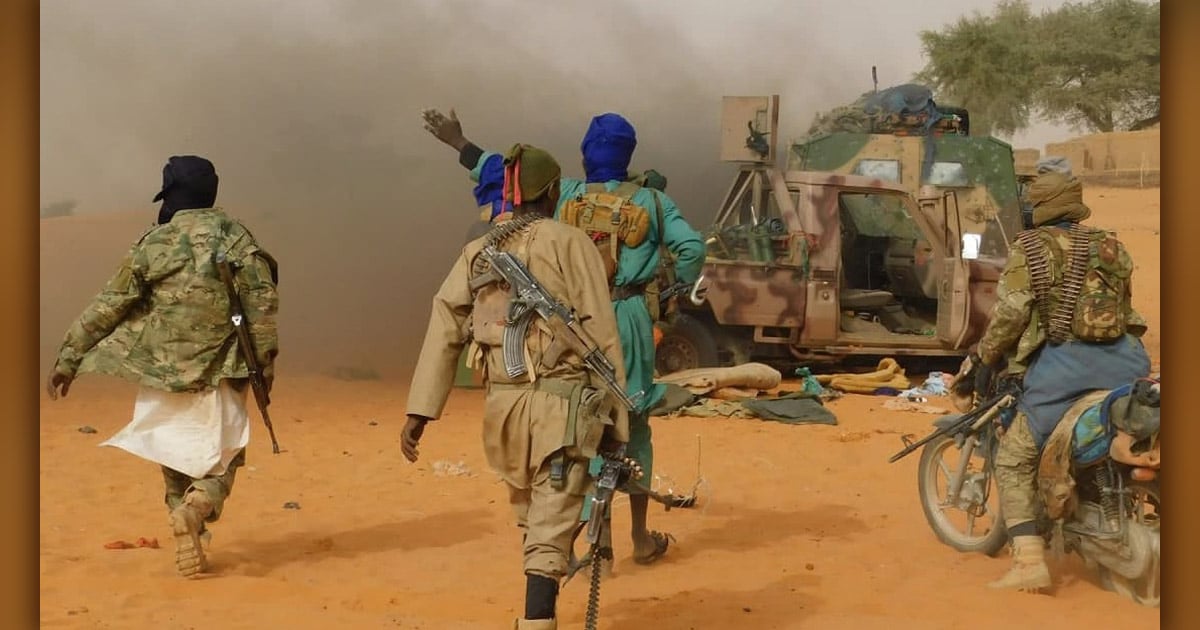 Masked men are approaching a camouflaged truck.