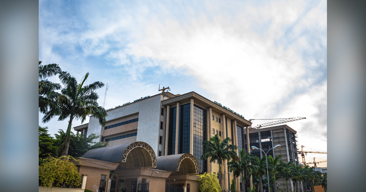 The court building is set against a lightly cloudy sky.