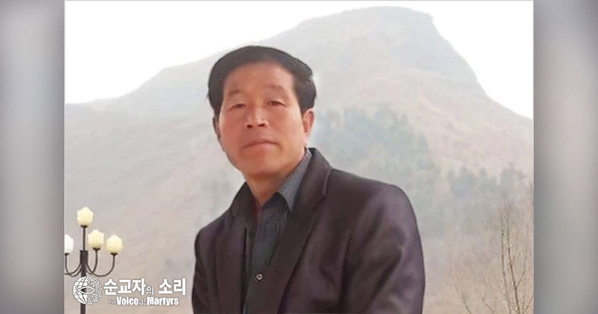 A hill is behind Deacon Jang Moon Seok.