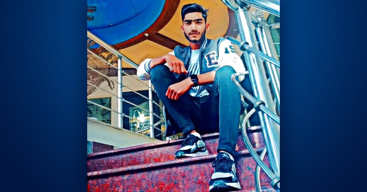 Farhan is sitting on some steps.