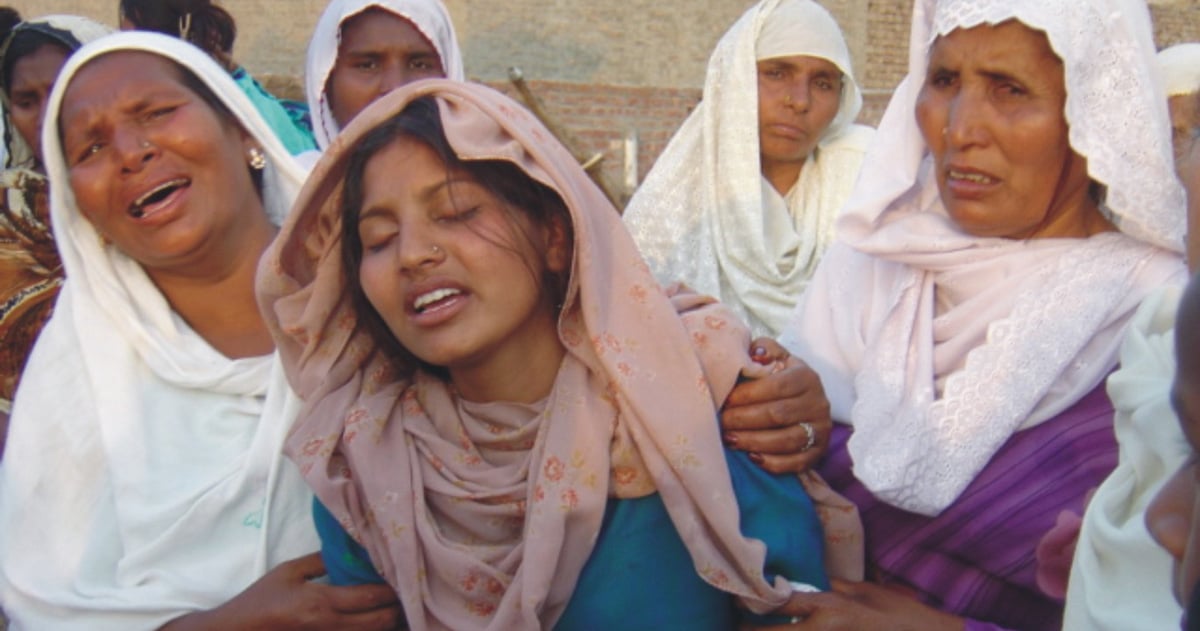 Women are weeping together, supporting a young woman in the front.