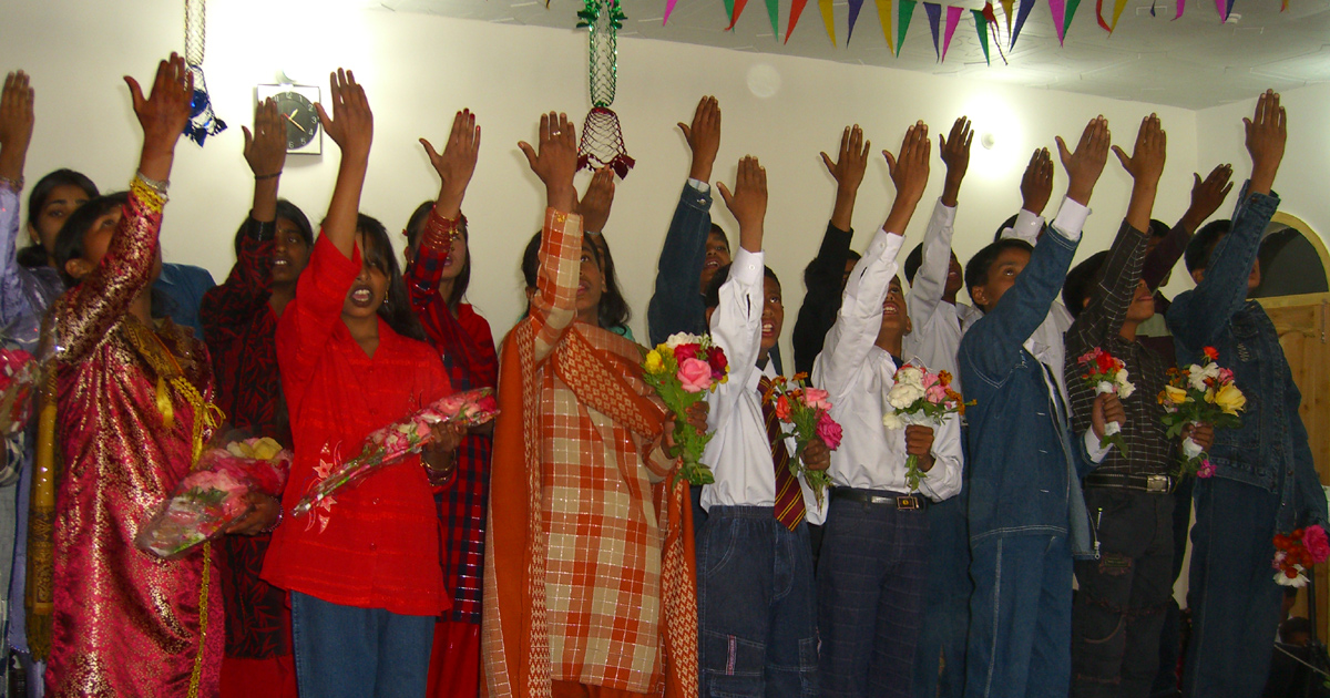 Believers have their hands raised in worship. Believers have their hands raised in worship.