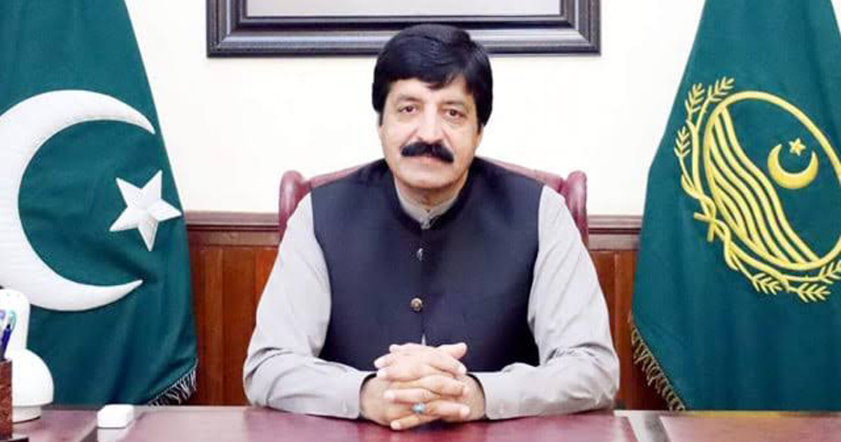 Governor Sardar Saleem Haider Khan is sitting at a desk. Governor Sardar Saleem Haider Khan is sitting at a desk.