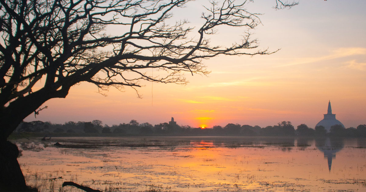 Scenic view of Anuradhapura District; lake in the foreground, town in the distance Scenic view of Anuradhapura District; lake in the foreground, town in the distance
