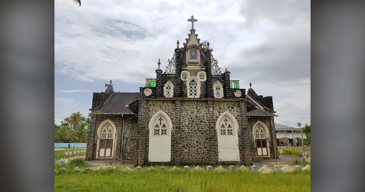 A small, ornately decorated church is set against light blue clouds. A small, ornately decorated church is set against light blue clouds.
