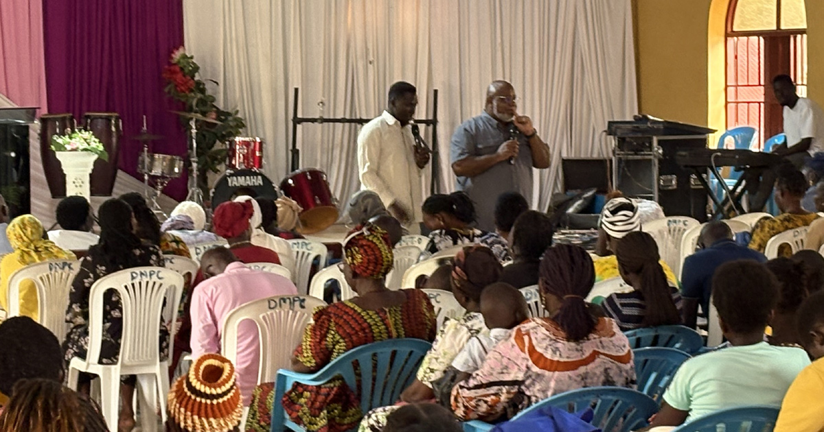 Stephen Wesley is teaching with a translator in a building full of people.