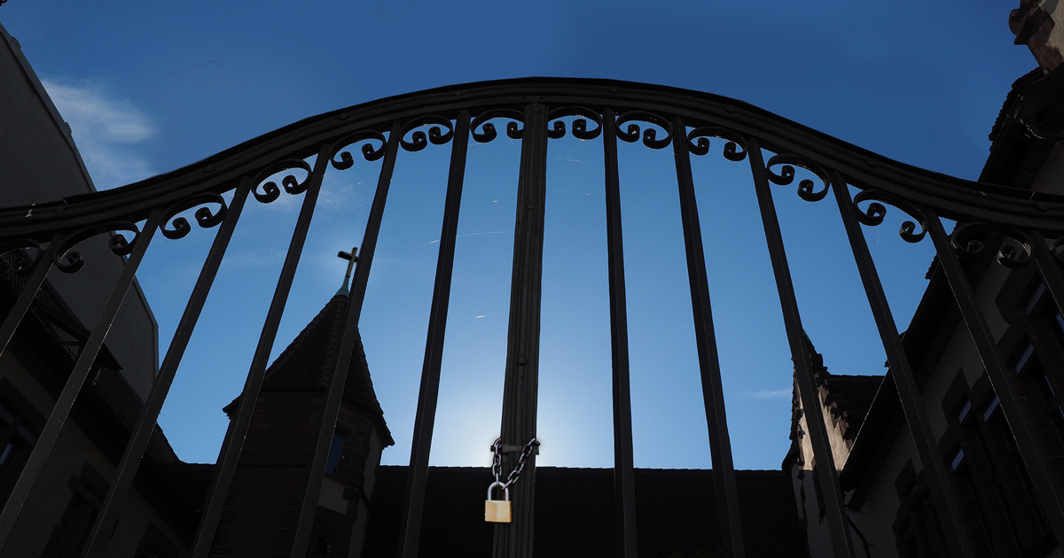 Locked gate with a church behind Locked gate with a church behind
