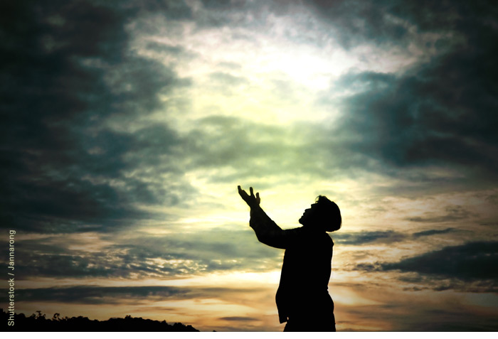 Man with his hands raised in prayer