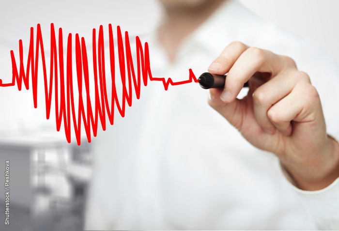 A man is drawing the pattern of a heartbeat. It forms the shape of a heart. A man is drawing the pattern of a heartbeat. It forms the shape of a heart.