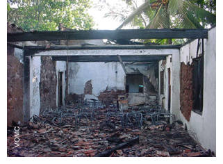 The Kesbawa Assembly of God Church is completely burned, leaving only the brick walls and some overhead beams.
