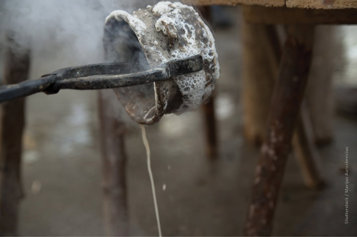 A small container with water pouring out A small container with water pouring out