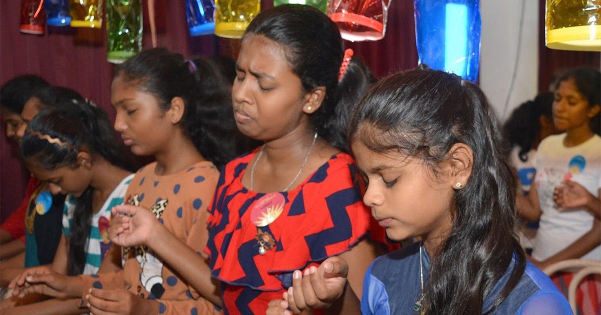 Women and girls are praying together. Women and girls are praying together.