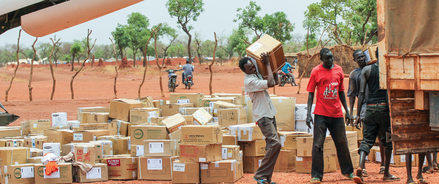 Sudan - Men loading boxes onto a truck Sudan - Men loading boxes onto a truck - Photo: VOMC