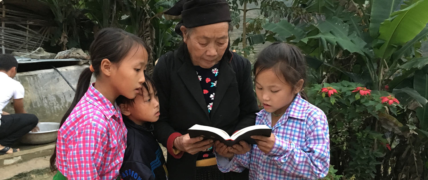 Vietnam - Elder Christian reading the Bible with children Vietnam - Elder Christian reading the Bible with children - Photo: VOMC